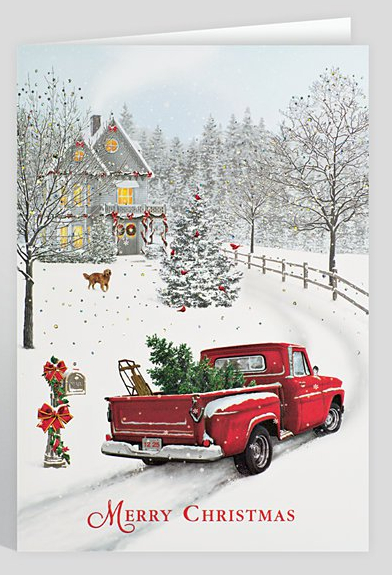 A red pickup truck with a Christmas tree in the bed drives down a snow covered driveway toward a large farmhouse decorated for christmas. The ground and trees are covered with snow. A dog walks across the front yard. Red bows and wreaths hang from the mailbox, a pinetree in the front yard and the house.